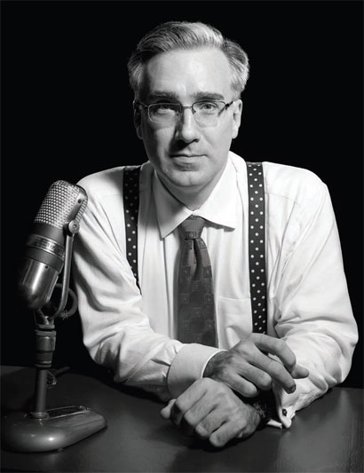 Portrait photo in black and white of Keith Olbermann in front of a mike.