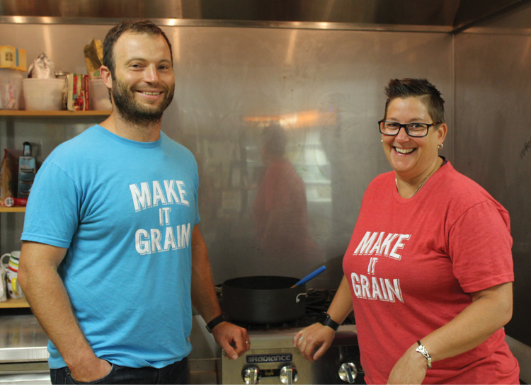 Grainful co-founders stand in a kitchen with "Make it Grain" T-shirts